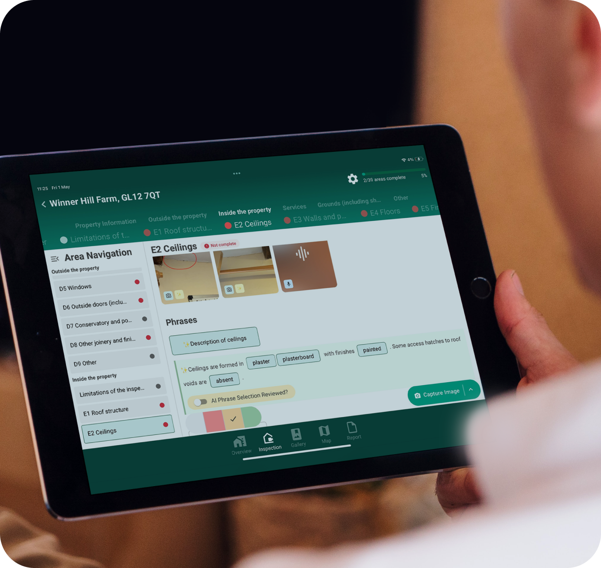 A housing officer reviewing a SurveySphere report building itself on an iPad